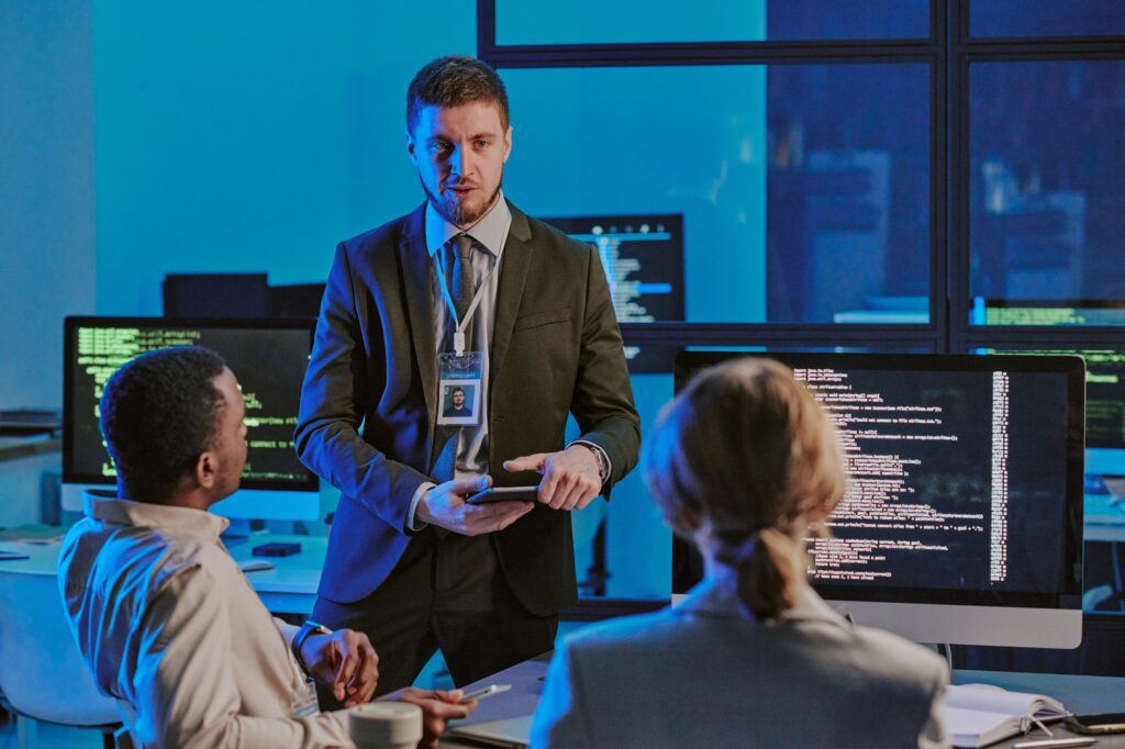 Young Man Speaking During Meeting In Cybersecurity Office