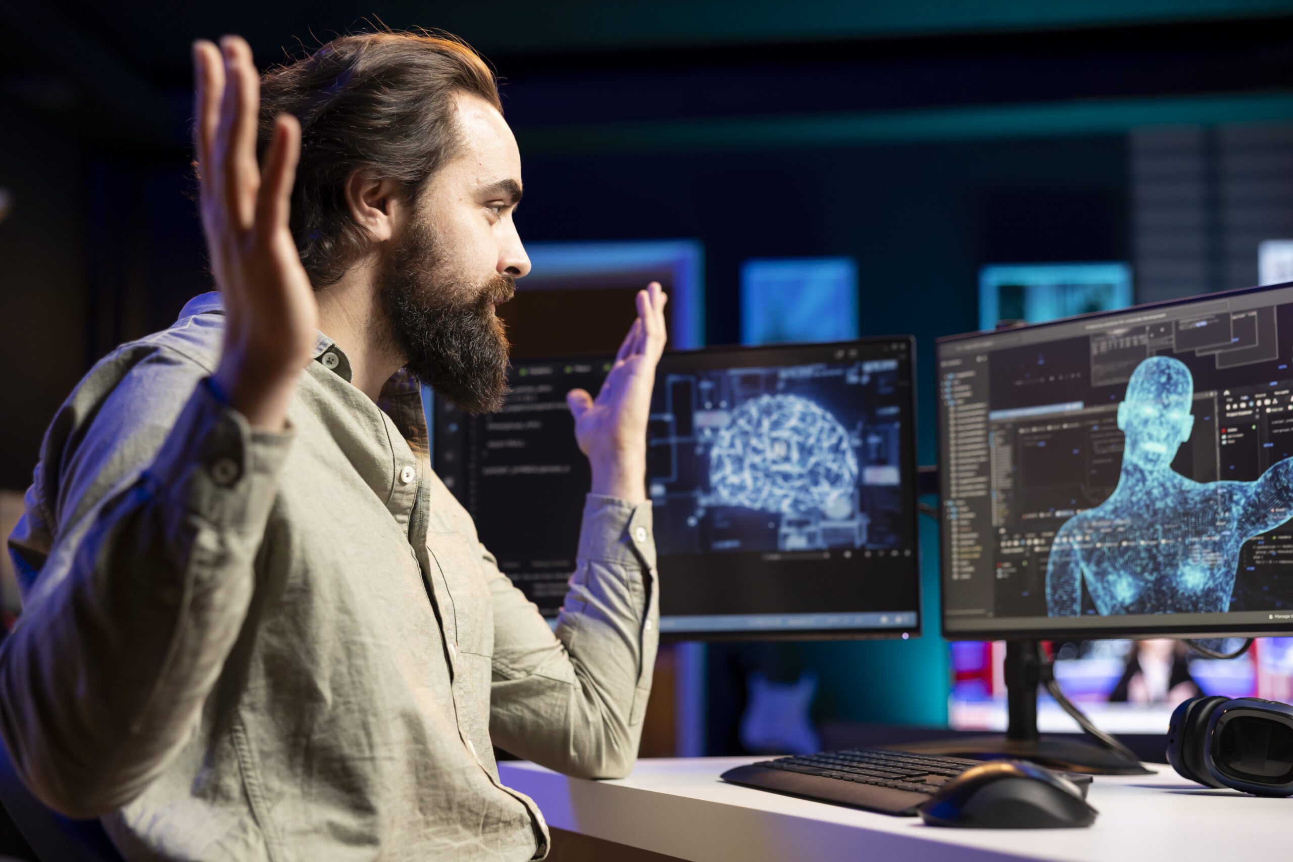 A person at a desk gestures toward computer screens displaying digital brain and human figure images, highlighting the power of Generative AI in transforming neural concepts into visual artistry.