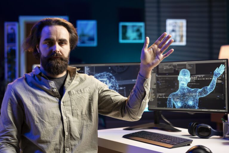 A man gestures at a computer screen, where a digital humanoid figure created by generative AI comes to life in the tech-themed office.