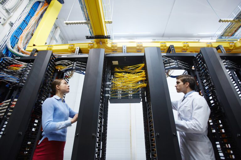 Staff of modern mining farm checking or testing new bitcoin storage system