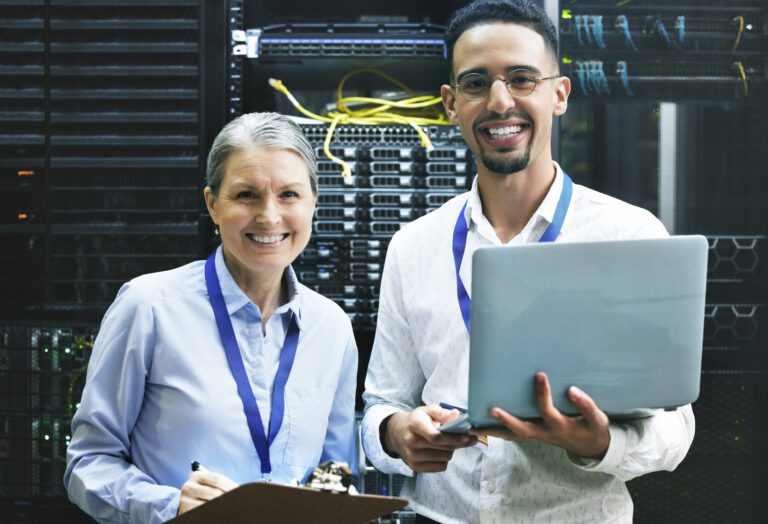 Teamwork makes technology work. Shot of two technicians working together in a server room