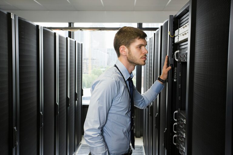A focused technician working on a server in a modern data center.