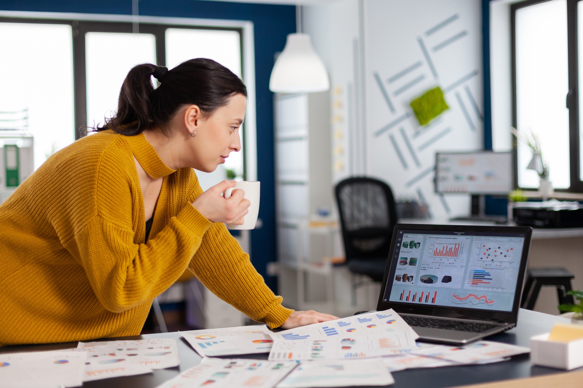 Corporate business woman in company office looking at statistics