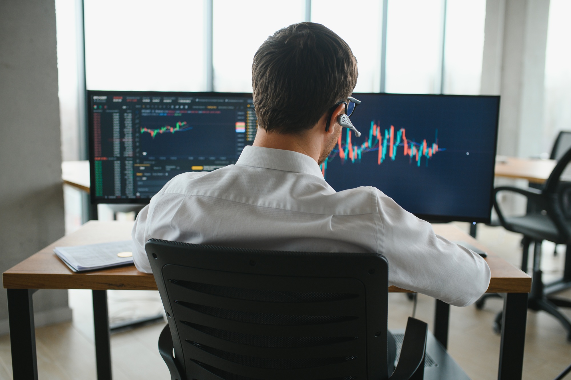 Serious business man trader analyst looking at computer monitor