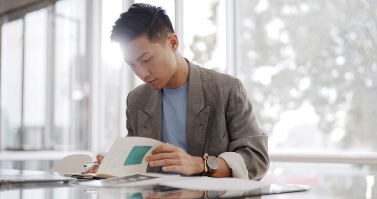 Businessman, writing report and documents with business plan proposal in conference room and compan