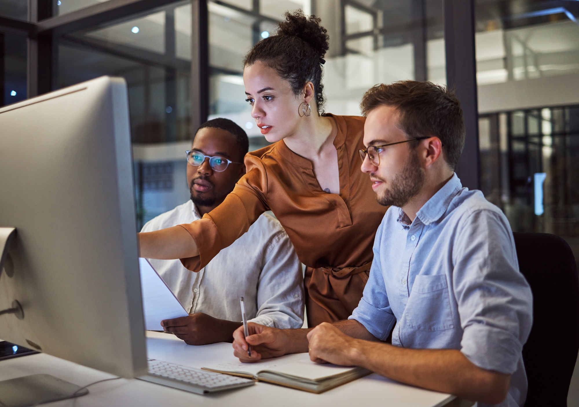 Learning, computer and training business interns in night office with manager, boss and leadership