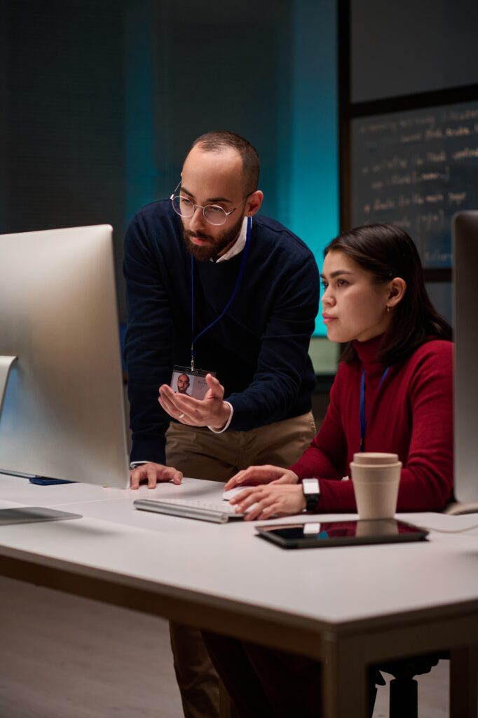Cybersecurity Team using Computer in Blue Light