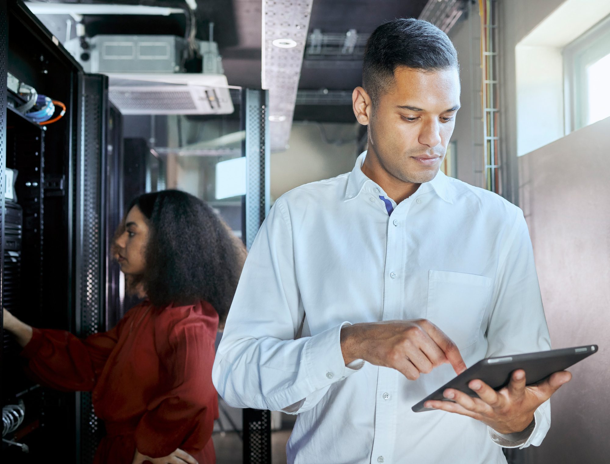 Management, server room and tablet with business people in data center for cloud computing, cyberse