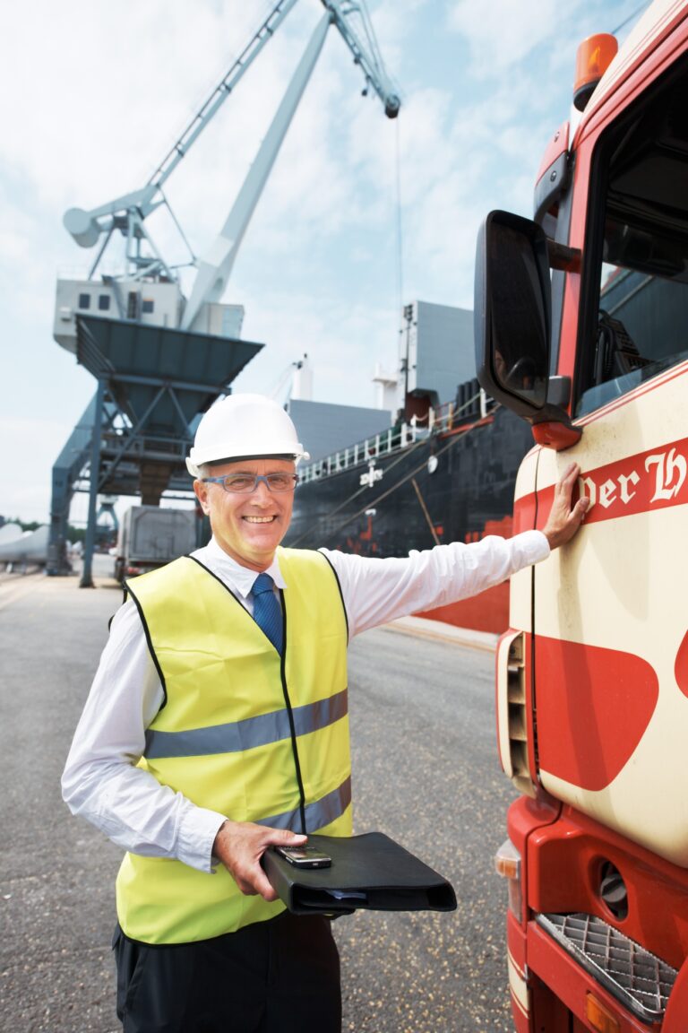 Portrait of a dock worker standing at the harbor amidst shipping industry activity
