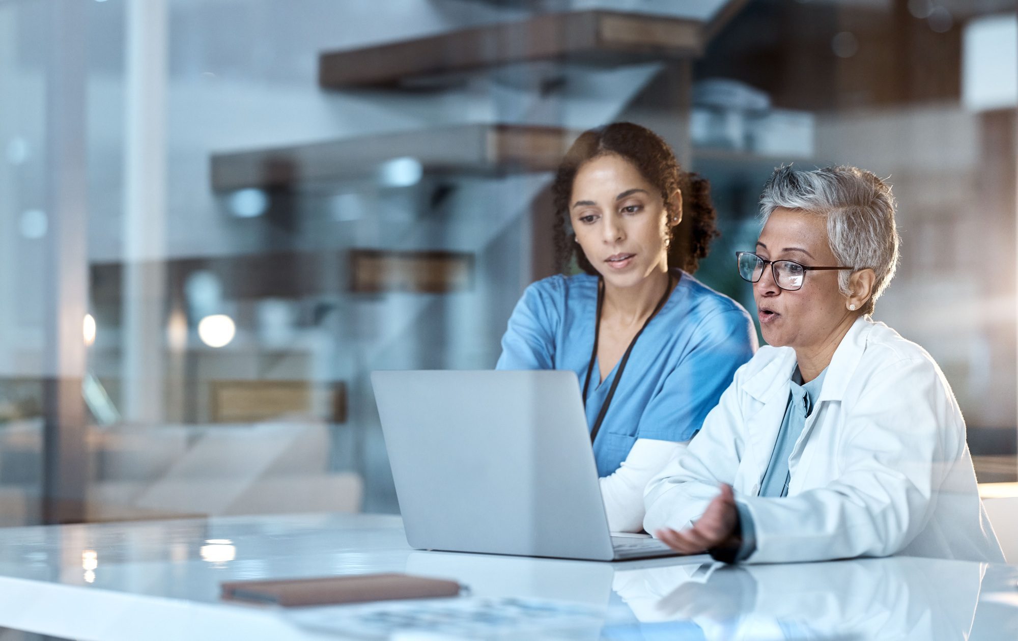 Team of doctors, healthcare and women with laptop, working together and digital hospital schedule o