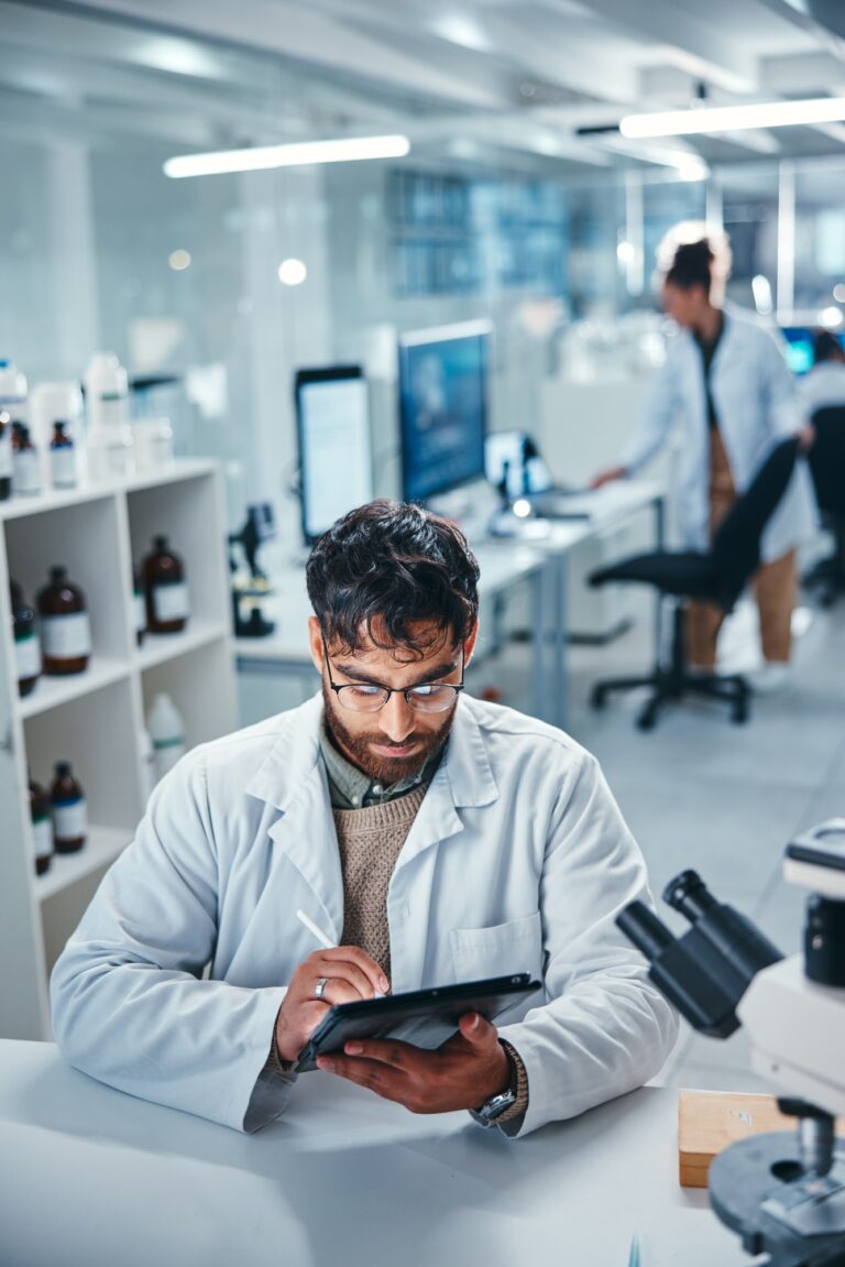 Scientist, man and writing on tablet in lab for microscope research, medical data and science infor