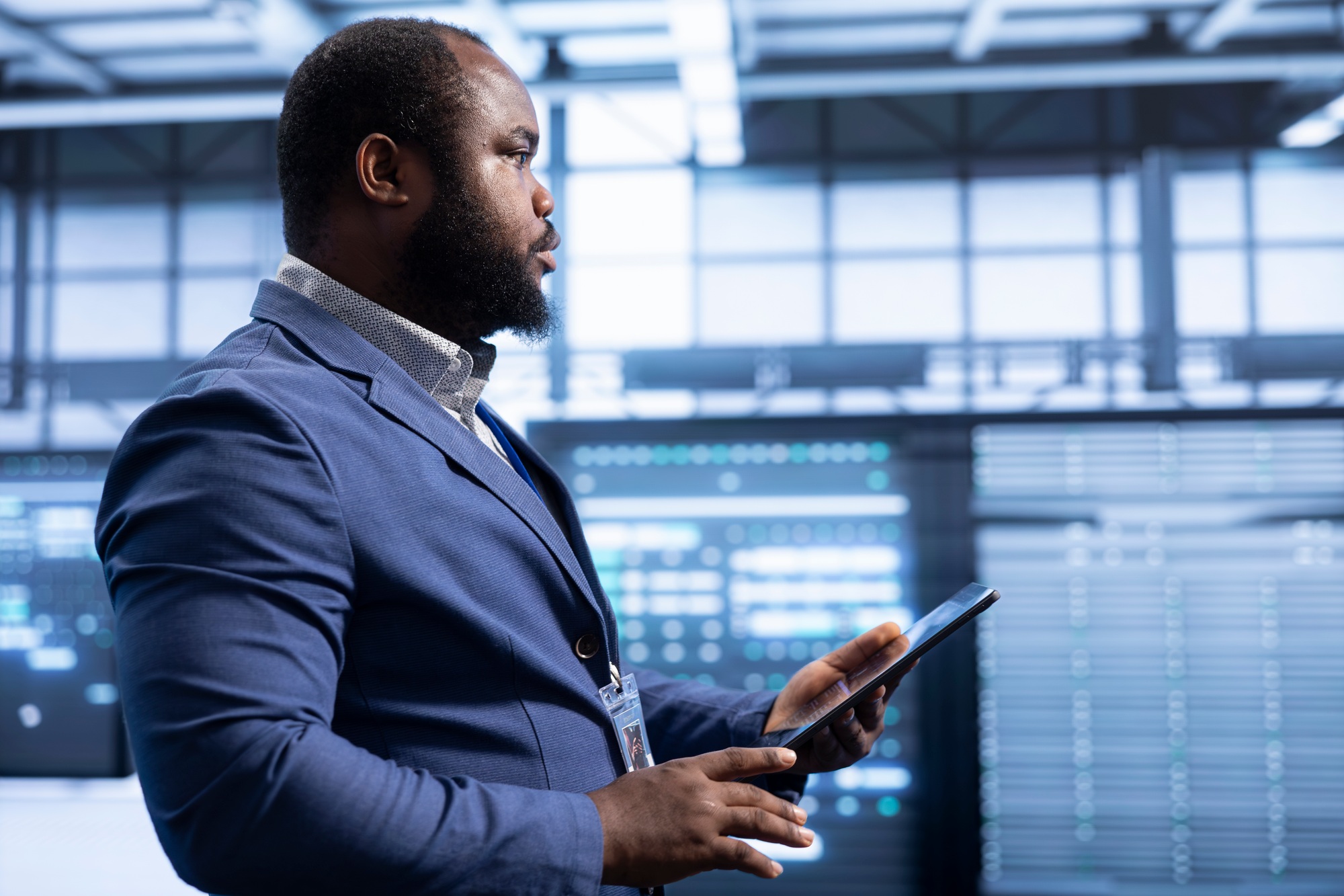 System administrator in data center checking rigs and hardware using tablet