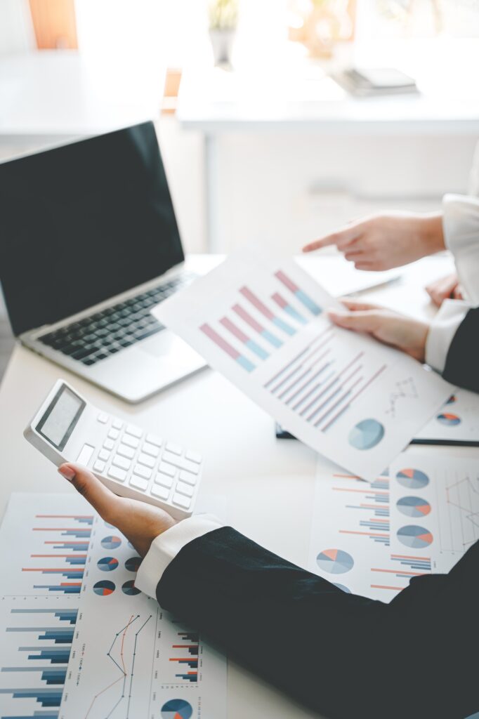 Teamwork with price chart analyzes business people on the table at the conference room.