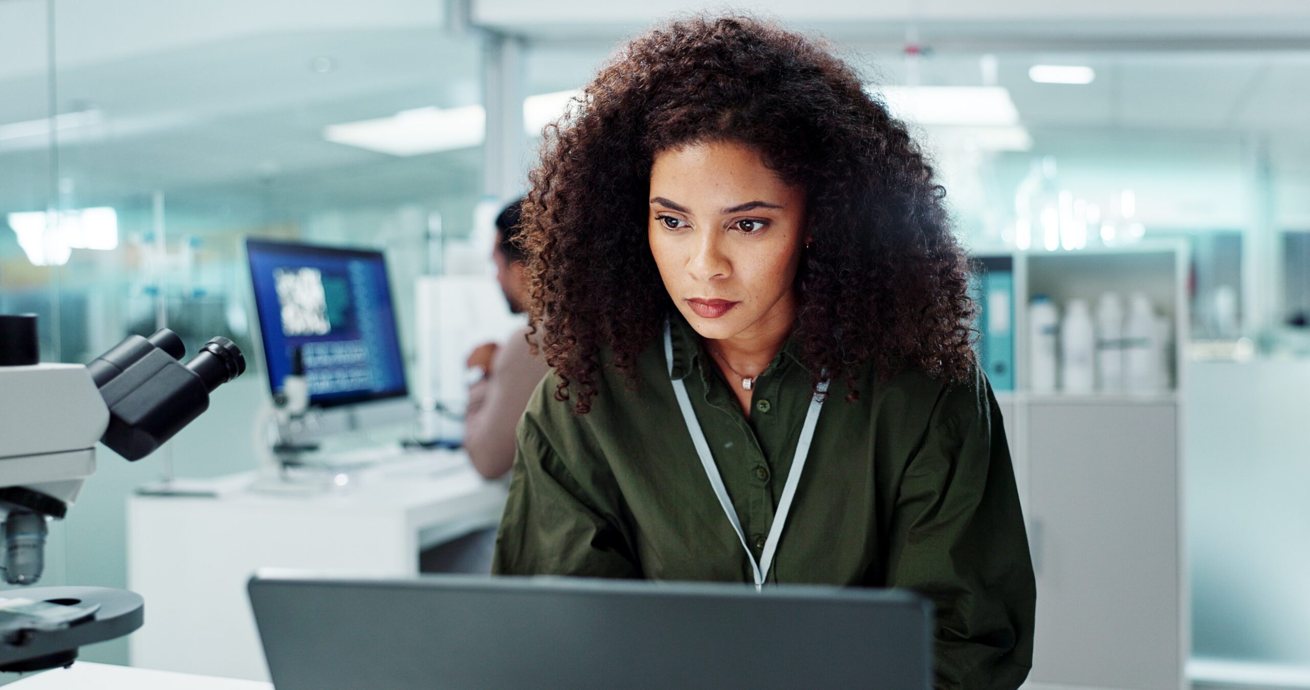 Woman. laptop and lab for research science or online internet for futuristic discovery, microscope .